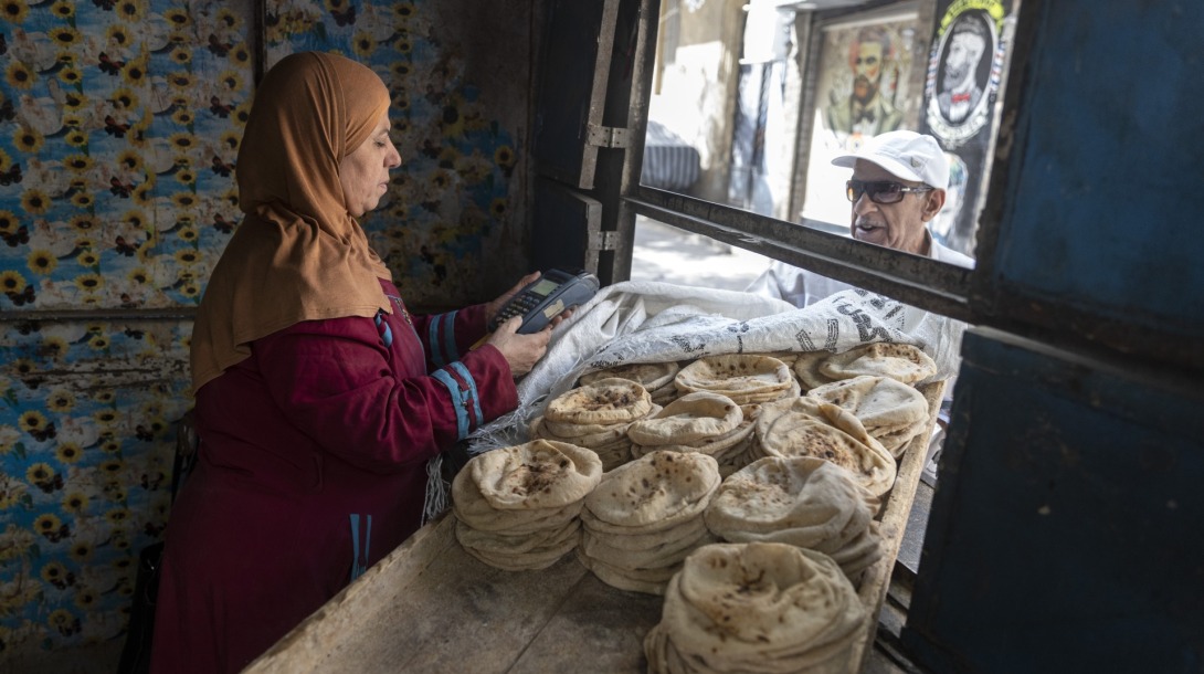 CAIRO, EGYPT - MAY 8: A man buys subsided Egyptian traditional 'Baladi' bread using the smart-card bread subsidy system from a governmental bread stand in Sayeda Zeinab Neighborhood on May 8, 2022 in Cairo, Egypt. Last month, Egypt introduced price controls on commercially sold bread in response to the rising price of wheat. Egypt imports 80% of its wheat supply from Russia and Ukraine, whose production and export have been disrupted by the invasion. (Photo by Roger Anis/Getty Images)