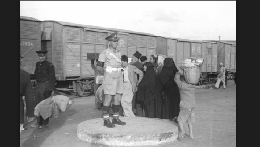 A British officer assisting in the evacuation of Haifa’s Palestinians, April 1948. Photo by Fred Csasznik. Source: The Israel Defense Forces and Defense Establishment Archive.